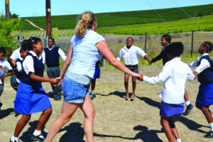 AIFS study abroad student volunteer with children in South Africa
