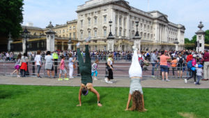 AIFS Abroad students doing handstands in front of Buckingham Palace in London, England