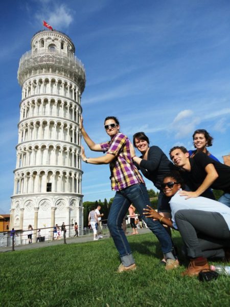 aifs abroad students holding up the leaning tower of pisa in italy