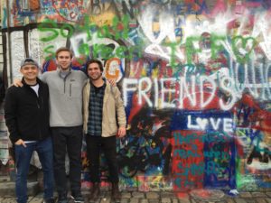 three aifs abroad students at john lennon wall in prague, czech republic