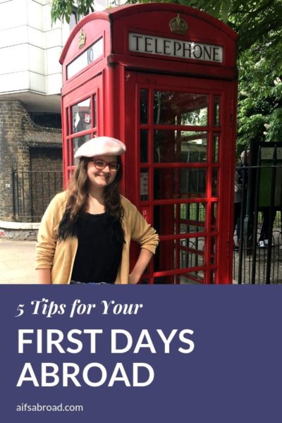 AIFS Study Abroad in London student poses at a traditional phonebooth at the beginning of her study abroad experience.
