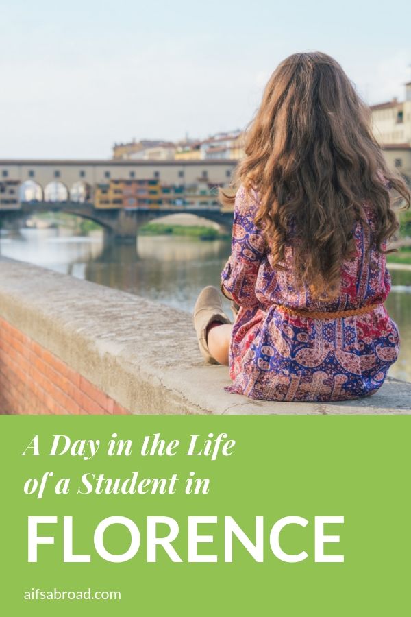 Pin image: A young woman sitting on the Arno River looking at the Ponte Vecchio in Florence, Italy with text overlay saying "a day in the life of a student in Florence"