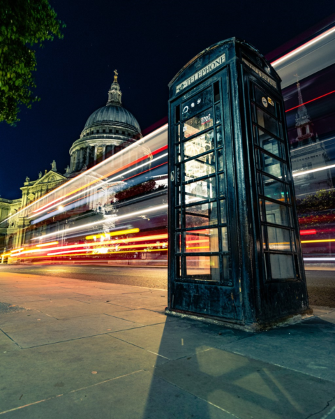 Picture of St Paul's Cathedral with unusal black phone box in forground.