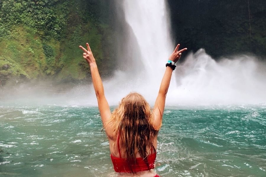 College student at waterfall in Costa Rica | AIFS Study Abroad