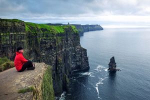 Young man at Cliffs of Moher in Ireland | AIFS Study Abroad