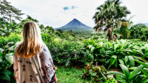 Young woman looking at environment and volcano in Costa Rica