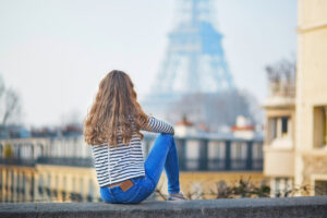 young girl outdoors near the Eiffel tower, in Paris