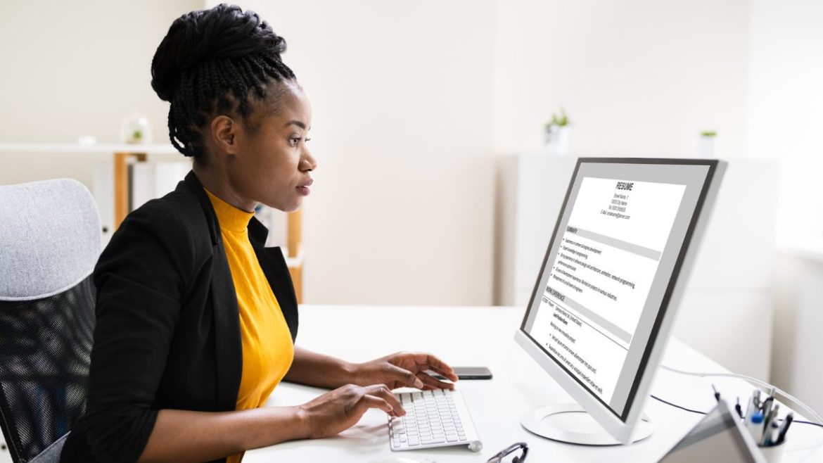 Woman at desk working on resume