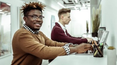 Two young professional men interning or working at an office