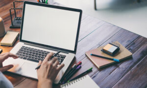 hands and laptop with blank screen