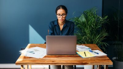 young professional female working remotely on laptop