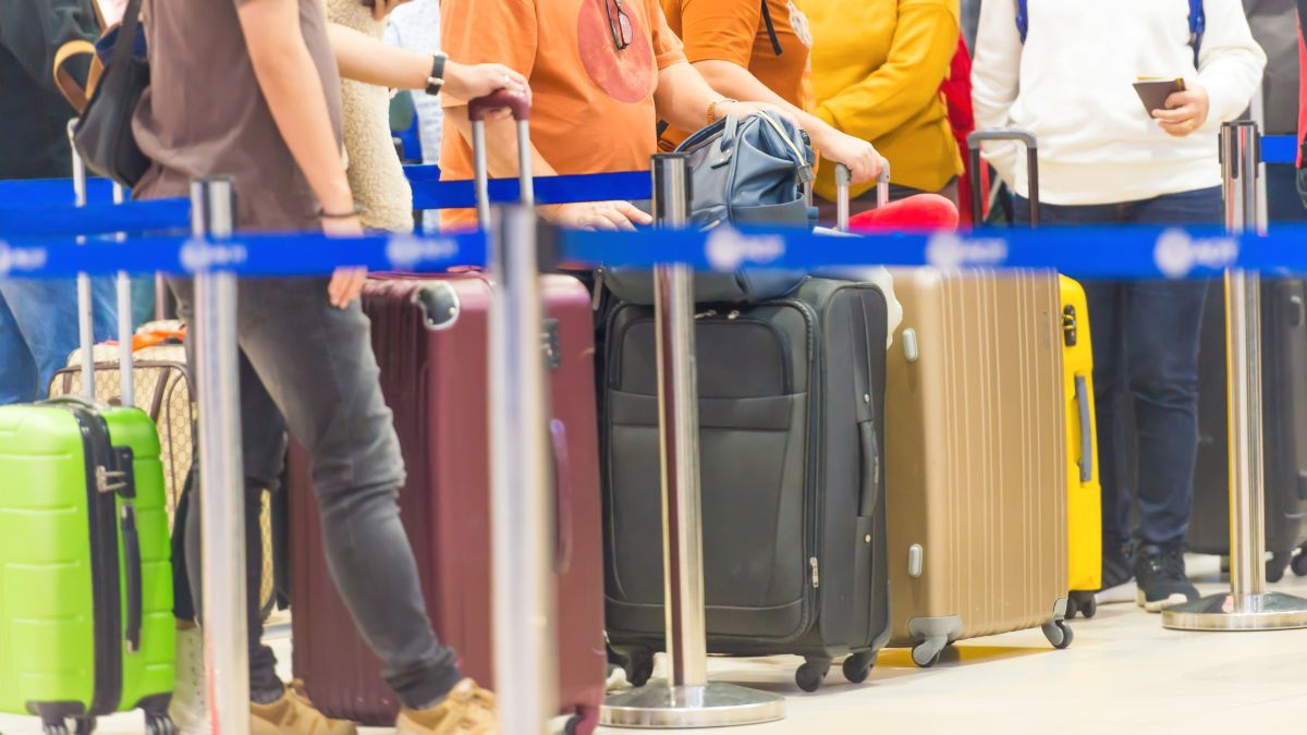 People in line at the airport with luggage