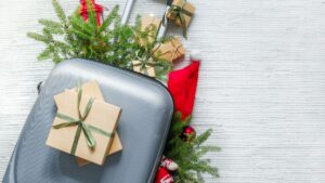 Suitcase with gifts and holiday decorations