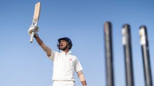 Cricket player holding up bat