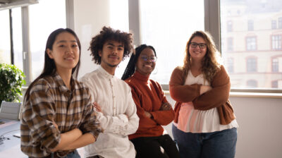 A group of young colleagues in the office are looking at the cam
