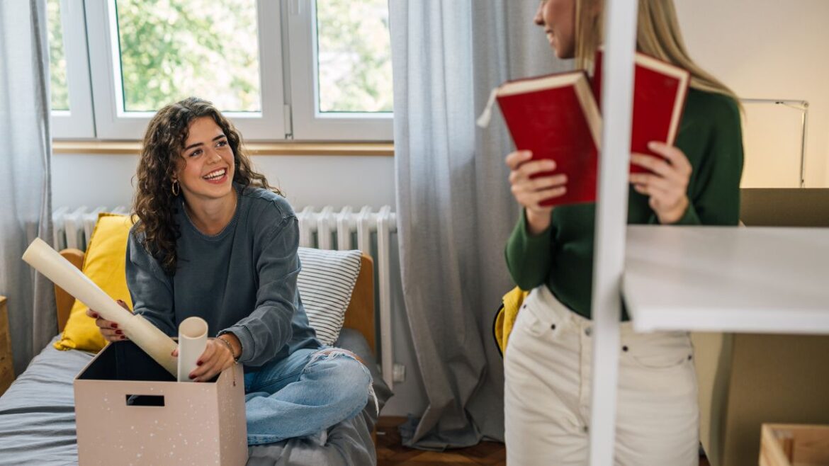 Two young women in a dorm room