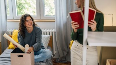 Two young women in a dorm room