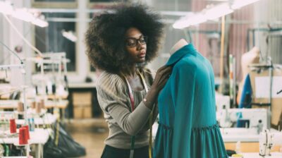 Young woman working on a piece of fashion clothing