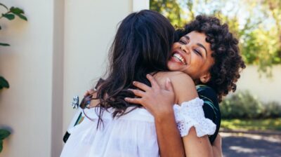 two women hugging welcome home