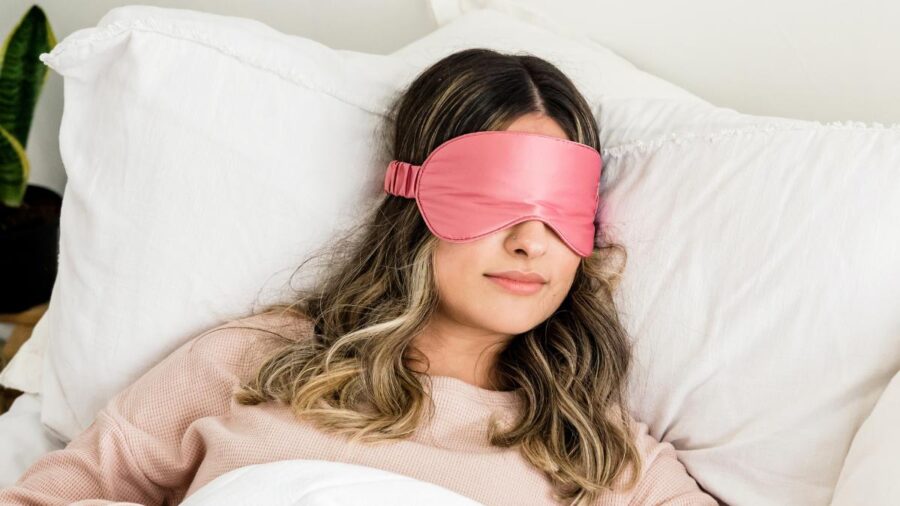 Young woman sleeping with eyemask on