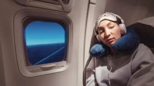 Woman asleep on plane in window seat