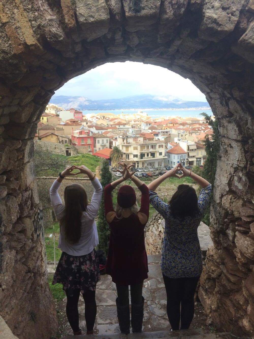 AIFS Abroad study abroad students in Greece making Greek Life sorority symbols with their hands