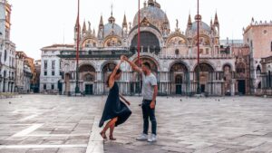 young couple dancing alone in st. mark's square, venice, italy