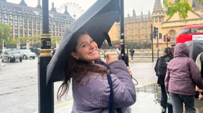 AIFS Abroad Alum Hannah from Towson University in London, England holding an umbrella in the rain