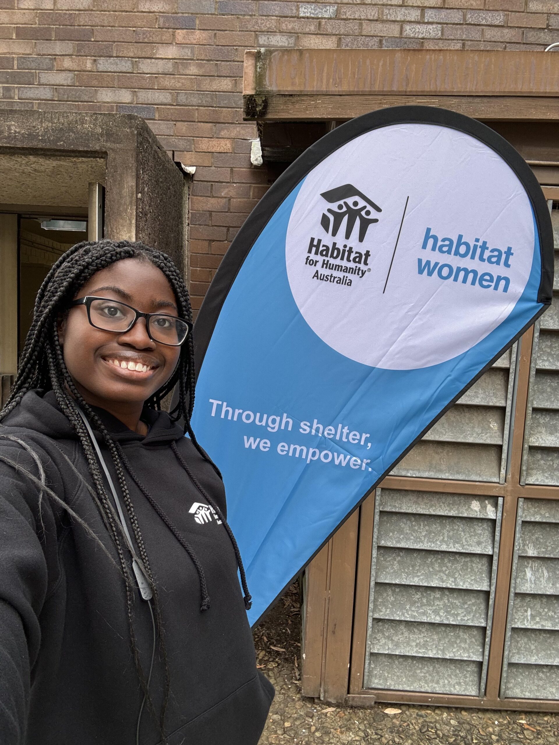 aifs abroad internship program participant in sydney, australia with habitat for humanity sign