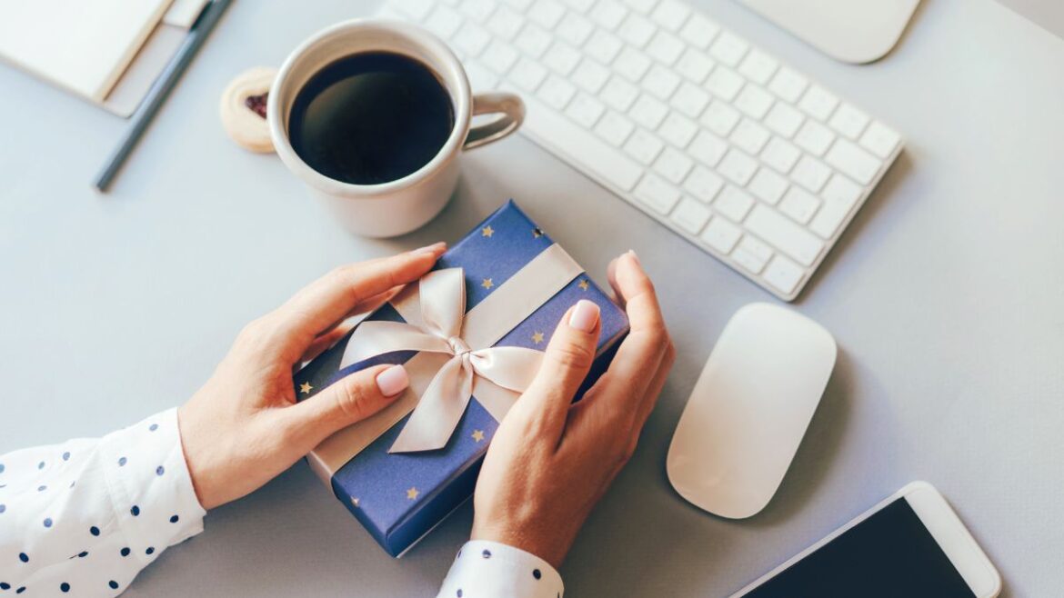 gift at desk with coffee, keyboard, mouse and other work accessories