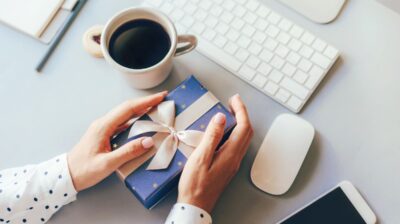 gift at desk with coffee, keyboard, mouse and other work accessories