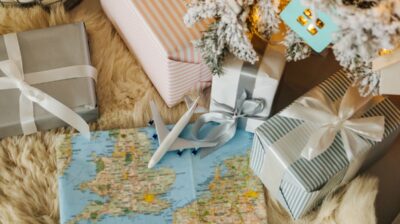 holiday gifts wrapped with map and airplane travel study abroad gift concept