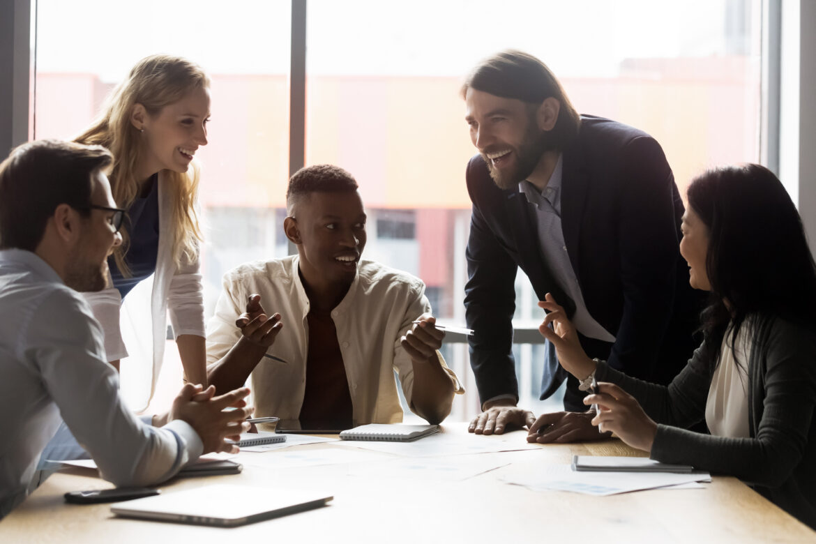 Colleagues discussing ideas at briefing in boardroom