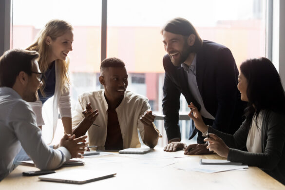 Colleagues discussing ideas at briefing in boardroom