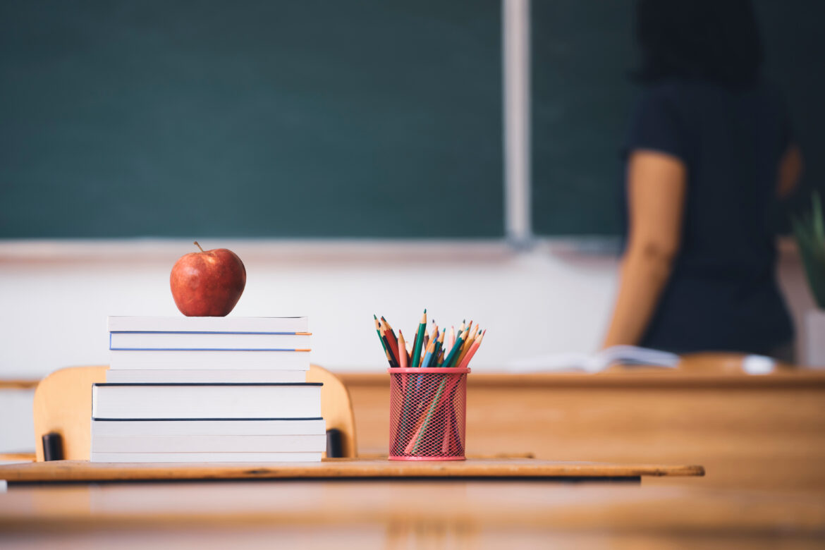 books and apple for teacher in school