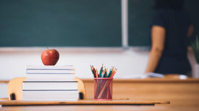 books and apple for teacher in school