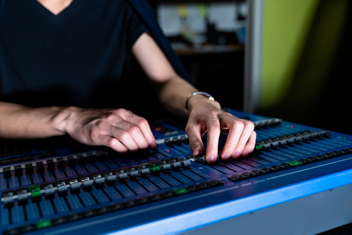 Theatre intern using sound mixer