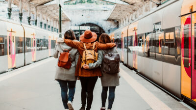 A group of young friends waiting relaxed and carefree at the station in Porto, Portugal before catching a train. Travel photography. Lifestyle.