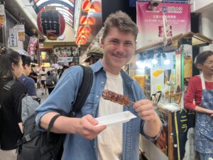 Student in Kyoto, Japan eating street food