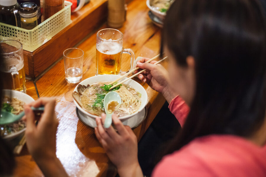 friends eat ramen at local restaurant during quiet lunch